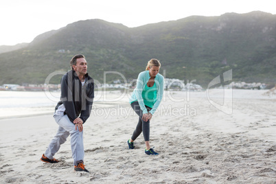 Mature couple doing stretching exercise