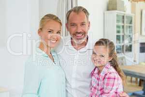 Portrait of parents with her daughter at home