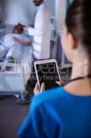 Female doctor using digital tablet in the ward