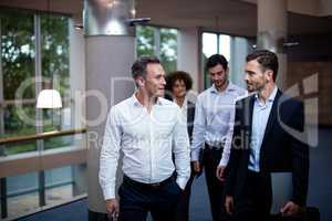 Business executives walking in a conference center lobby