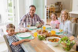 Family having meal on dinning table at home