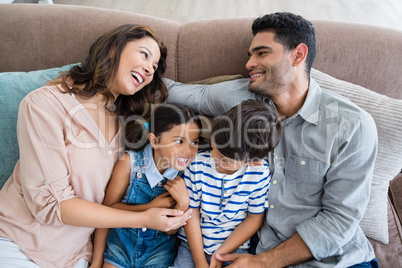 Parents and kids having fun in living room