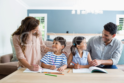 Parents assisting their kids in doing homework