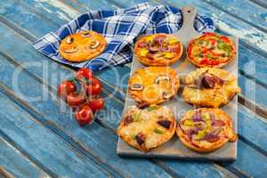 Various delicious italian pizza served on pizza tray with tomatoes