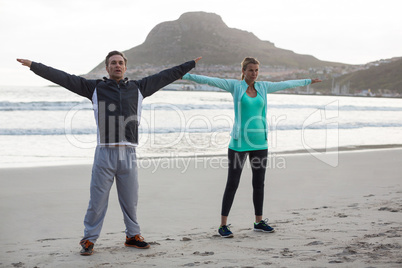 Mature couple doing stretching exercise