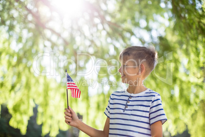 Boy holding small american flag