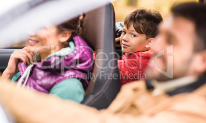 Smiling boy in back seat of car