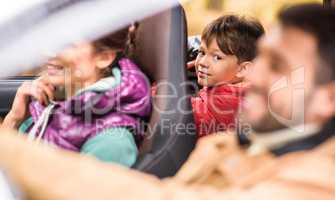 Smiling boy in back seat of car