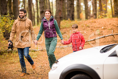 Family walking in autumn forest