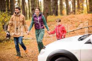Family walking in autumn forest