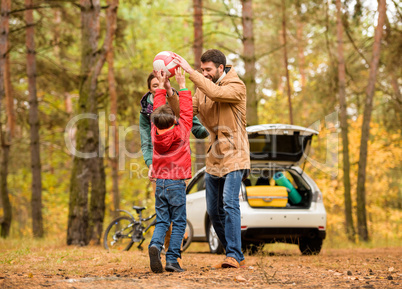 Happy family playing with ball