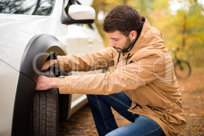 Man checking car tyre