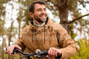 Smiling man sitting on bicycle