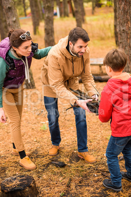 Happy family collecting firewood