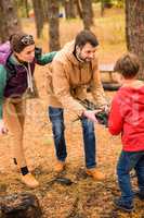 Happy family collecting firewood