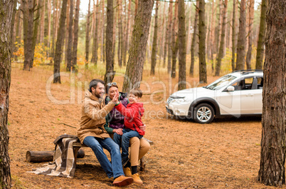 Happy family in autumn forest