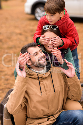 Happy family playing in autumn forest