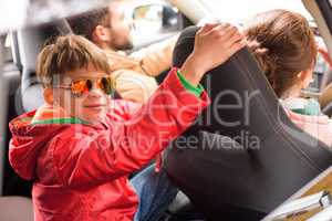 Happy family travelling by car