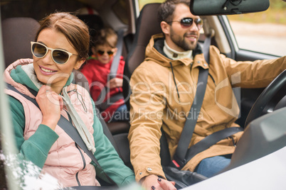 Happy family travelling by car