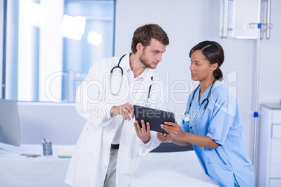 Doctors having discussion on digital tablet