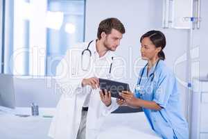Doctors having discussion on digital tablet