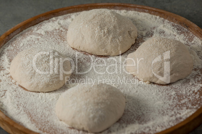 Pizza dough and flour on rolling board