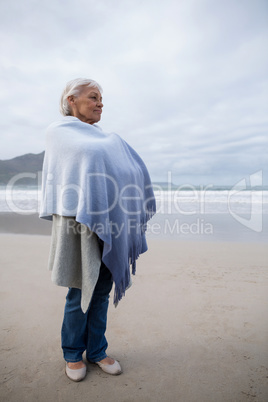 Senior woman standing on the beach