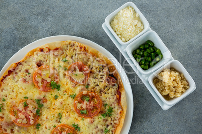 Italian pizza served with ingredients on a plate