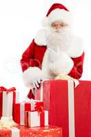 Santa Claus with pile of Christmas gifts
