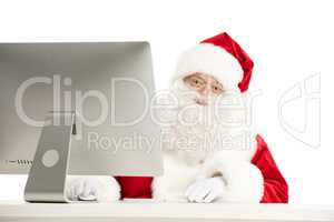Santa Claus sitting at the desk with computer