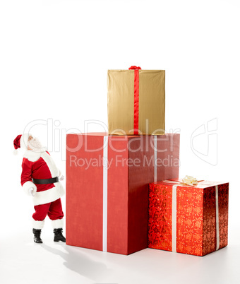 Santa Claus with pile of Christmas gifts