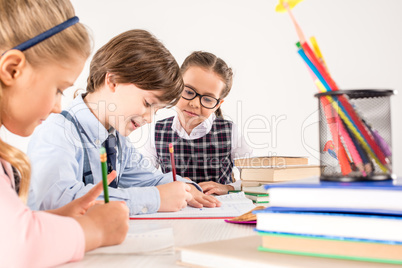 Children writing in notebooks