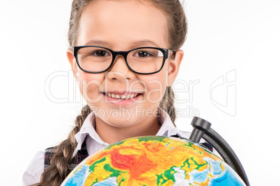 schoolgirl smiling with globe