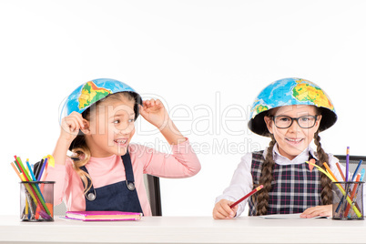 Schoolgirls with halves of globe on heads