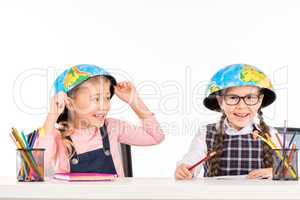 Schoolgirls with halves of globe on heads