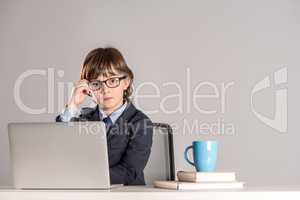 Schoolchild in business suit looking at camera