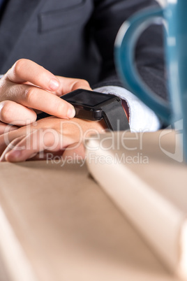 Schoolchild in business suit using smart-watch