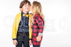Schoolgirl kissing in cheek schoolboy