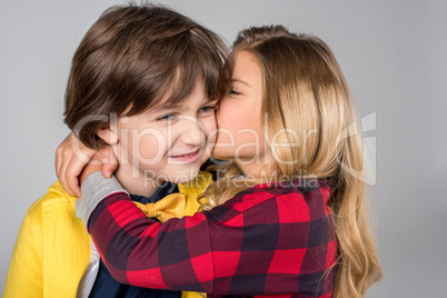 Schoolgirl kissing in cheek schoolboy