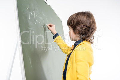 Schoolboy writing on blackboard
