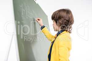Schoolboy writing on blackboard