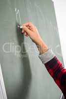 Schoolgirl writing on blackboard
