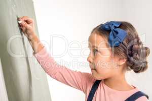 Schoolgirl drawing on blackboard