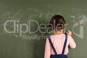 Schoolgirl drawing on blackboard