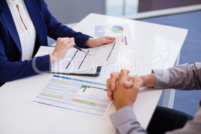 Business executives discussing over document