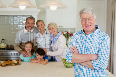 Portrait of happy family standing in kitchen