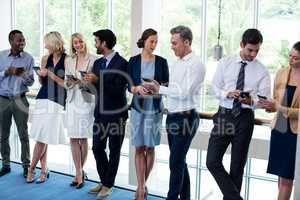 Business executives using mobile phone