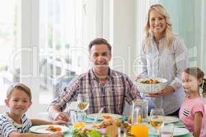 Family having meal on dinning table at home