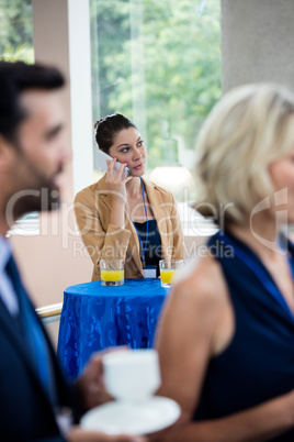 Female business executive talking on mobile phone