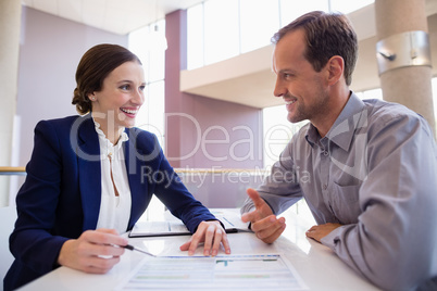 Business executives discussing over document